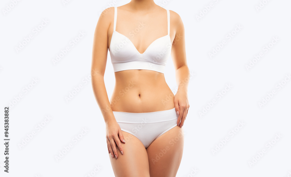 A slender swarthy woman in underwear on a white background. Healthy lifestyle, sport and diet. A slender swarthy woman in underwear on a white background. Healthy lifestyle, sport and diet.