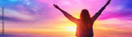 A person embraces a vibrant sunset, capturing a moment of freedom and joy against a colorful sky.