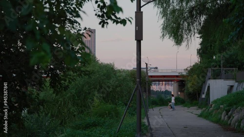Romantic Couple Taking a Joyful Jump Shot Selfie at Sunset on a Riverside Path in Nodeul Island, Seoul, South Korea – Urban Evening Moment