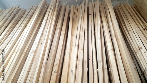 Wooden thin boards close-up in a hardware store. Facade cut wooden boards for construction, renovation, interior.  Wooden board, block, plank, new long boards. Wood products, lumber, stack of boards. photo