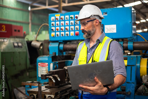 Industrial man engineer supervisor wear uniform and helmet using laptop are checking system machine at factory. manager technician manufacturing. Workers industrial factory.