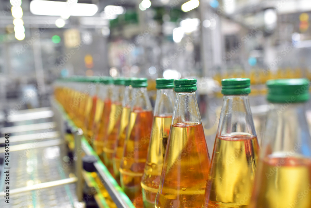 apple juice in glass bottles in a factory for the food industry - bottling and transport apple juice in glass bottles in a factory for the food industry - bottling and transport