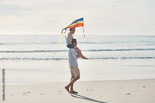 Father, flying kite and son on beach together for holiday, travel or vacation in summer. Carry, family or love with single parent man and boy child on sand by ocean or sea for bonding or freedom