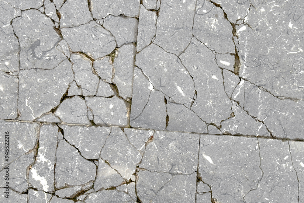 Obraz premium Cracked exterior floor tile abstract distressed surface. Gray abstract broken background