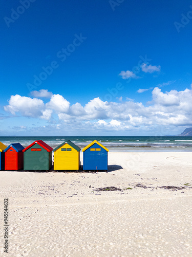 The iconic Muizenberg Beach huts for people to change in and out of bathing suits situated on Muizenberg Beach, Cape Town, South Africa