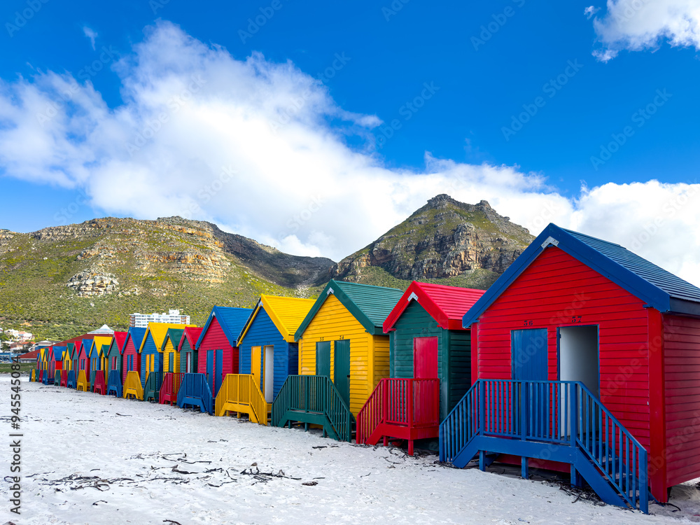 The iconic Muizenberg Beach huts for people to change in and out of bathing suits situated on Muizenberg Beach, Cape Town, South Africa