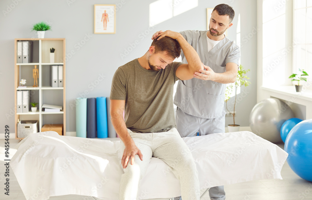 Therapist providing a neck and hand massage to a patient during a rehabilitation session in a hospital. Physiotherapy treatment and care, physical medicine, stretching targeted to aid in the recovery. Therapist providing a neck and hand massage to a patient during a rehabilitation session in a hospital. Physiotherapy treatment and care, physical medicine, stretching targeted to aid in the recovery.