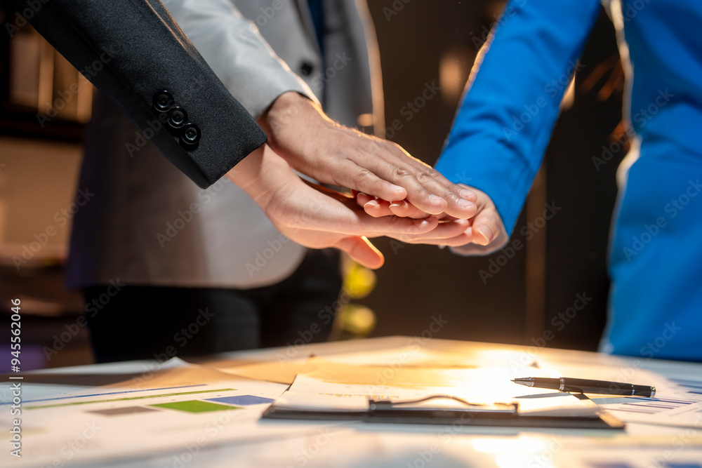 Three people are shaking hands in a business meeting Three people are shaking hands in a business meeting