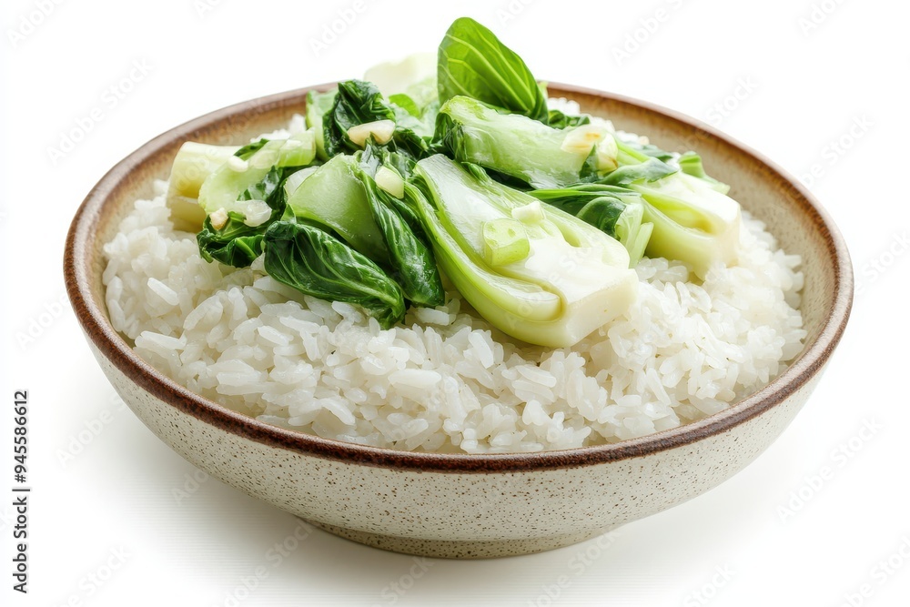 A bowl of steamed rice topped with fresh bok choy and garlic. A bowl of steamed rice topped with fresh bok choy and garlic.