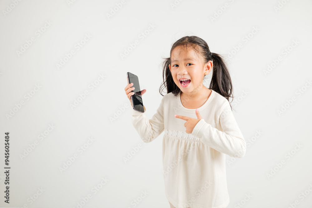 Portrait Asian happy young kid girl smile making finger pointing on screen smartphone in hand, Kindergarten children attractive shopping online application isolated studio shot white background Portrait Asian happy young kid girl smile making finger pointing on screen smartphone in hand, Kindergarten children attractive shopping online application isolated studio shot white background