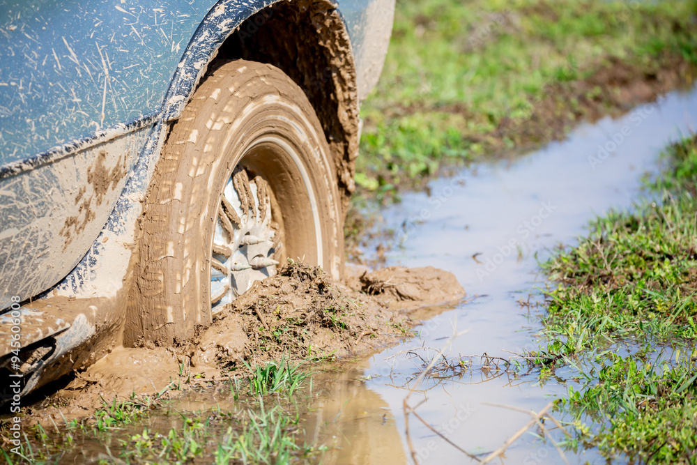 Car wheel stuck in mud, motorsport, mud tire testing. Off-road driving, car breakdown. Emergency evacuation. Car wheel stuck in mud, motorsport, mud tire testing. Off-road driving, car breakdown. Emergency evacuation.