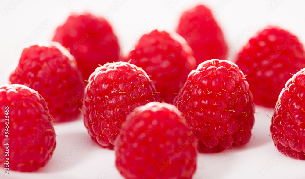 Handful of raspberry berries on white background Handful of raspberry berries on white background