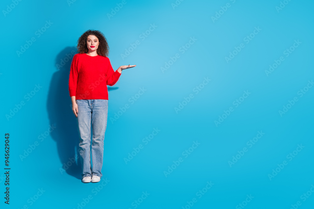 Full length photo of lovely young lady show measure empty space dressed stylish red garment isolated on blue color background Full length photo of lovely young lady show measure empty space dressed stylish red garment isolated on blue color background