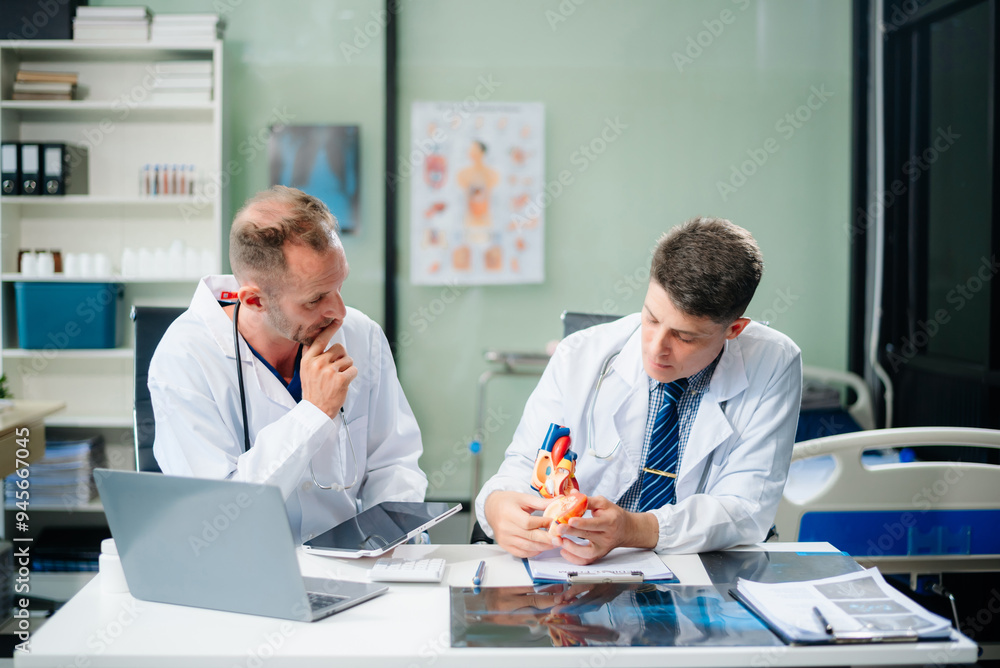 Diverse team of doctors and specialists brainstorming with digital tools, discussing test results and planning in hospital Diverse team of doctors and specialists brainstorming with digital tools, discussing test results and planning in hospital