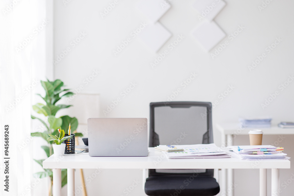 Laptop Computer, notebook, and eyeglasses sitting on a desk in a large open plan office space after working hours
Laptop Computer, notebook, and eyeglasses sitting on a desk in a large open plan office space after working hours