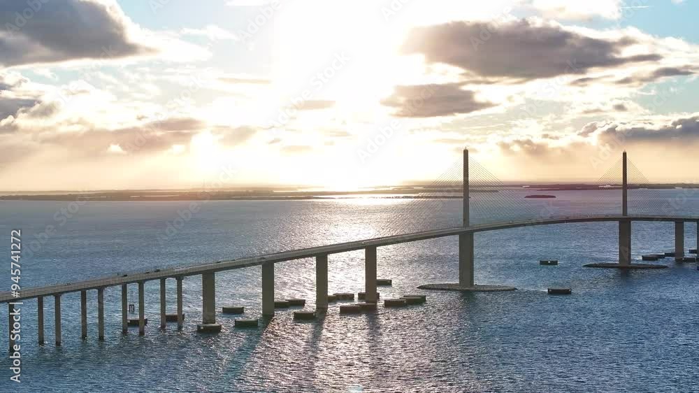 Aerial view of the skyway bridge over Tampa Bay at sunset with beautiful reflections on the water, St Petersburg, United States. Aerial view of the skyway bridge over Tampa Bay at sunset with beautiful reflections on the water, St Petersburg, United States.