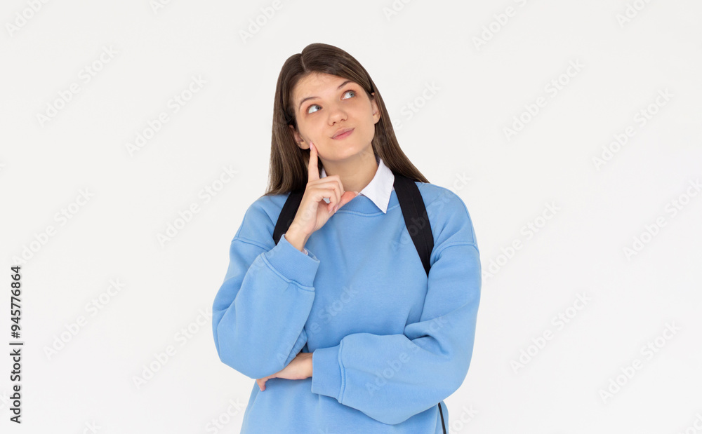 Cute woman thinking about smth. Young brunette student girl is thoughtful with backpack on white background Cute woman thinking about smth. Young brunette student girl is thoughtful with backpack on white background