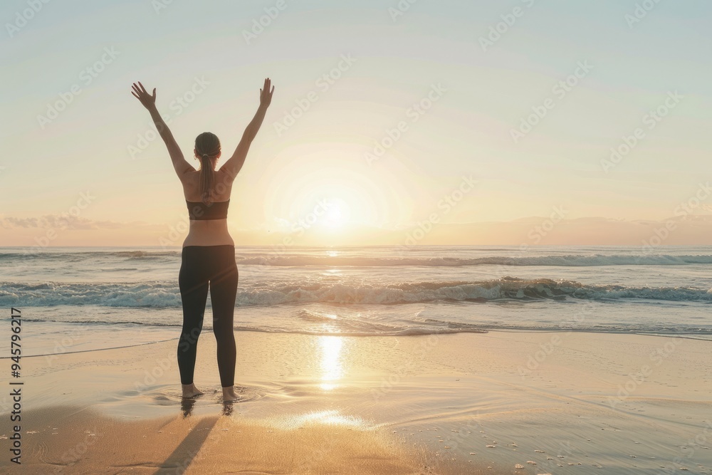 Fototapeta premium A person standing on the beach at sunset, arms raised in joy. This captures freedom and happiness. Ideal for wellness and relaxation themes. Generative AI