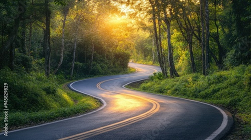 Beautiful road winding through a forest at sunrise, symbolizing a fresh start and serene journey.