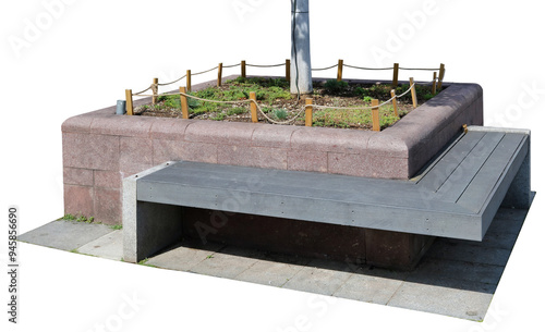 Bench for rest next to granite flowerbed with grass and tree isolated photo