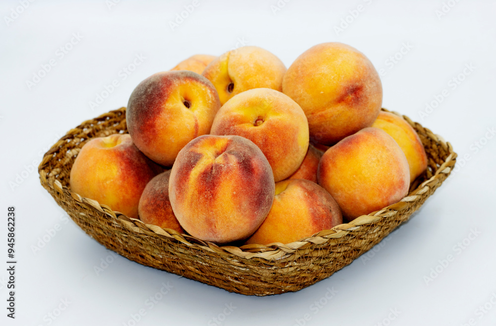 Peach, one of the most beautiful fruits of the summer season with its taste and smell, in a basket Peach, one of the most beautiful fruits of the summer season with its taste and smell, in a basket