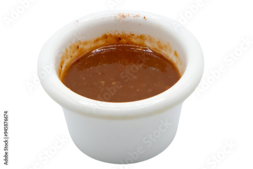 Red hot chilli pepper sauce in ceramic bowl isolated on a white background.