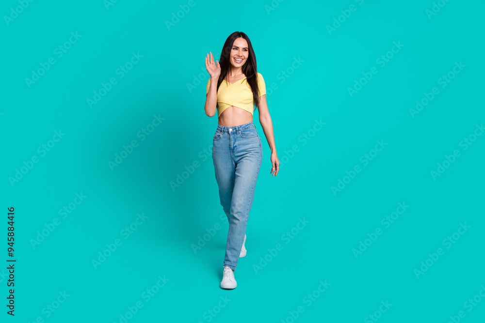 Full body portrait of pretty young woman walk arm wave empty space wear top isolated on turquoise color background Full body portrait of pretty young woman walk arm wave empty space wear top isolated on turquoise color background