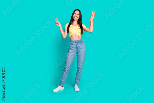 Full body portrait of pretty young woman show v-sign wear top isolated on turquoise color background