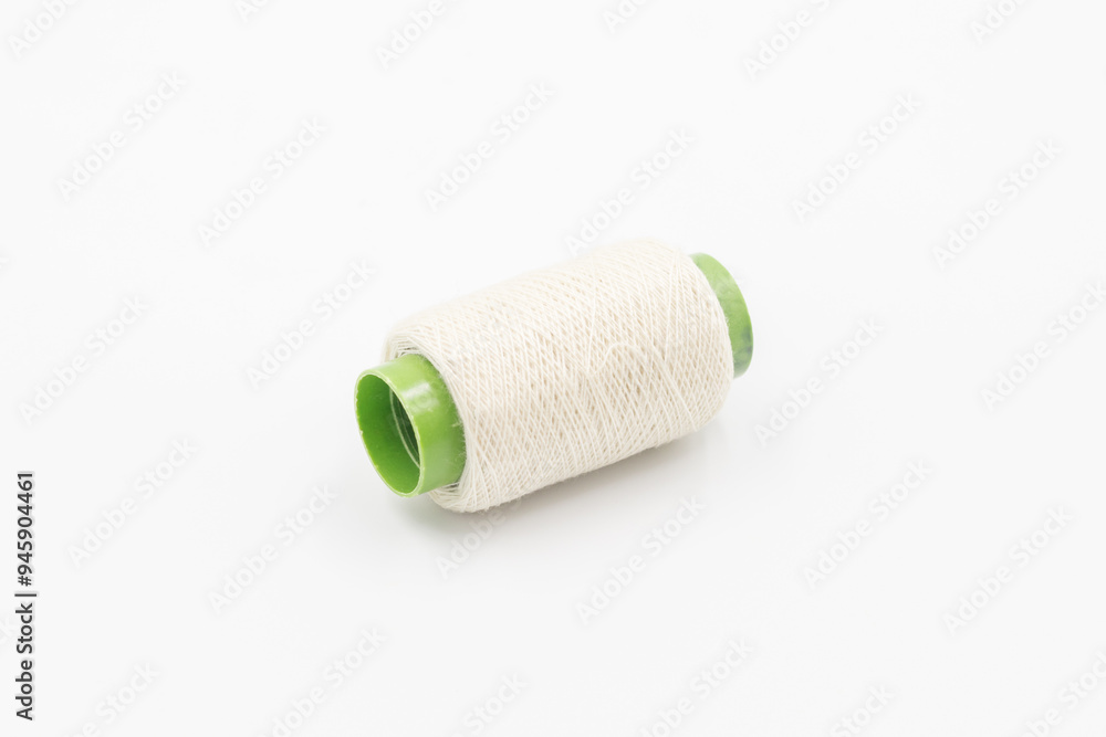 Colorful Spool of sewing thread, spool of industrial threads, Colored spools of thread on a white background. Colorful Spool of sewing thread, spool of industrial threads, Colored spools of thread on a white background.