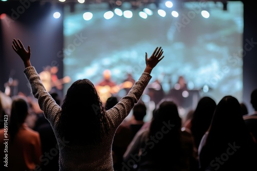 Hands in the air, people who are praising God and Jesus at a church service with worship band in the background,