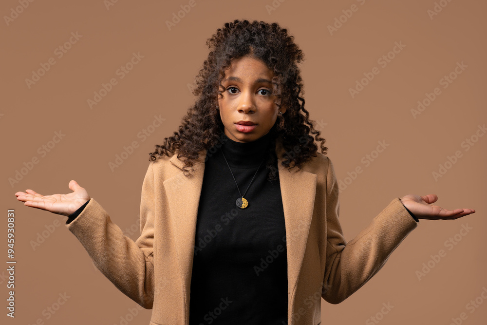 Dissatisfied indifferent african teenager girl, can't help, gesture of dont know Dissatisfied indifferent african teenager girl, can't help, gesture of dont know