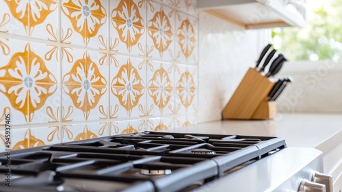 A kitchen with a Spanish-style tile backsplash, featuring hand-painted tiles with floral and geometric designs in warm colors photo