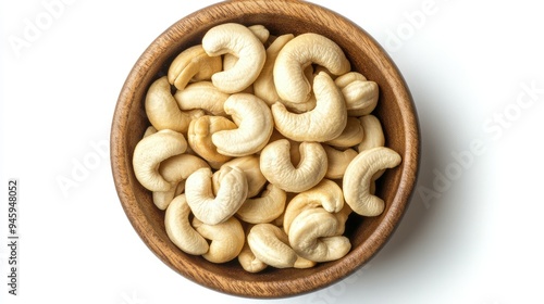 Cashew nuts in a wooden bowl, top view, isolated on a white background. Ideal for promoting natural and healthy foods.