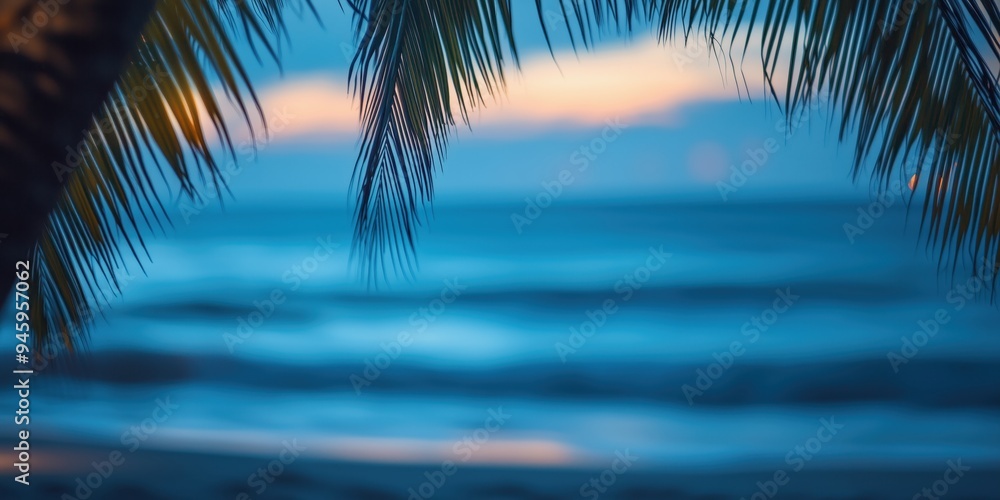 Beautiful defocused beach background framed by palm trees at twilght Beautiful defocused beach background framed by palm trees at twilght