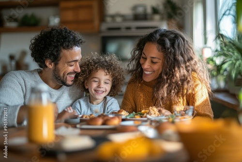 A loving family of mixed-race parents and their adopted child enjoy breakfast together at a cozy kitchen table filled with warmth and morning light.