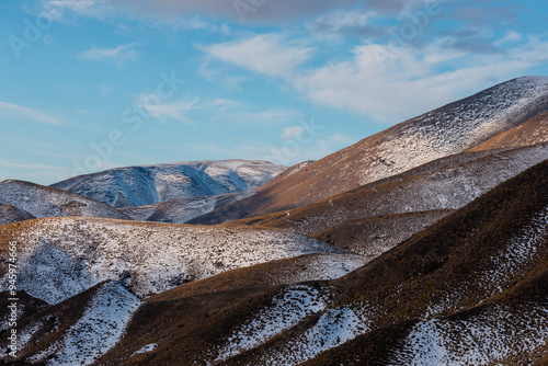 Layers of mountains with little snow in New Zealand. photo