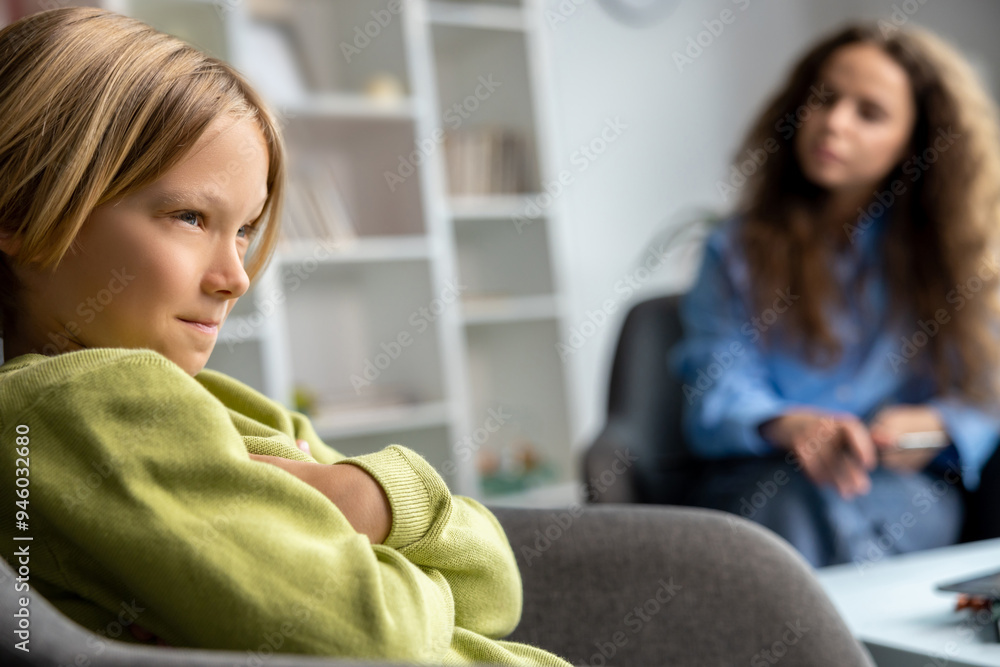 Blonde boy looking upset and unhappy during speech therapy Blonde boy looking upset and unhappy during speech therapy