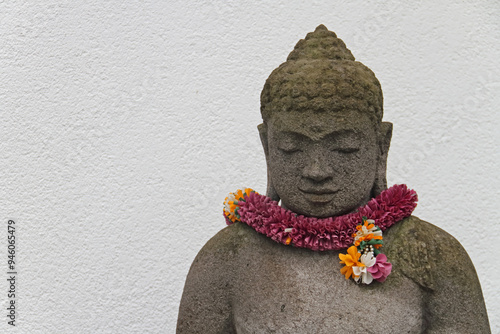 Buddha figure decorated with a flower wreath for the blossom festival