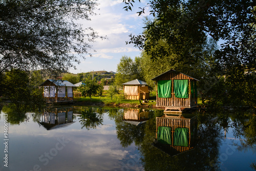 Wooden house by the lake. Cottage on the river bank. Cottage for rest. House in the forest