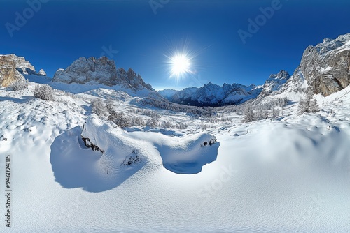 A snow covered mountain range with a bright sun shining on it. The scene is peaceful and serene photo