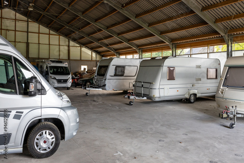 Caravans and campers from private individuals in a large shed at a farm