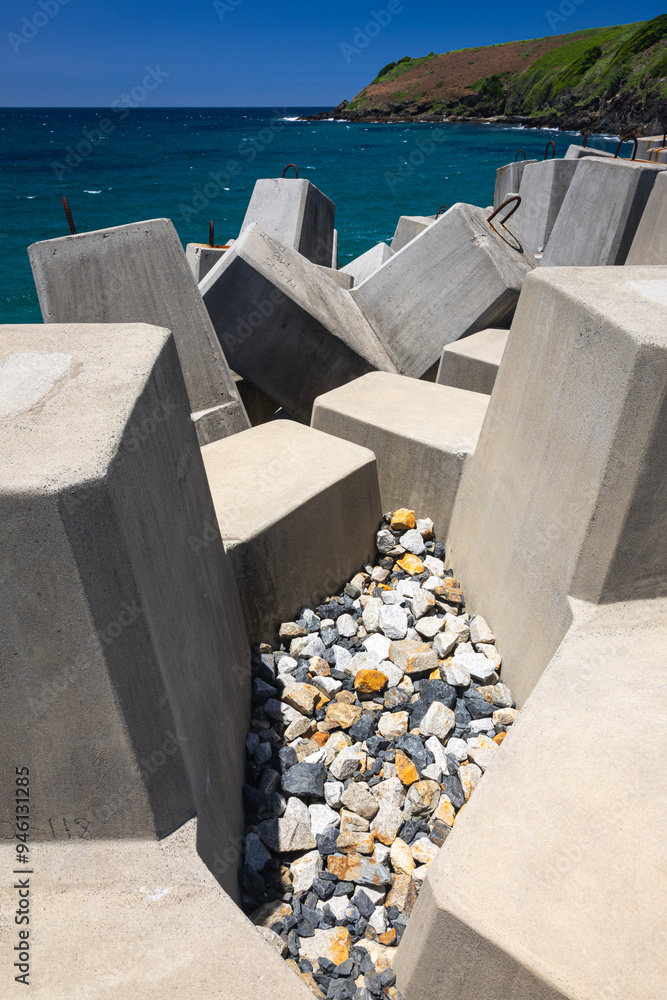 stone barriers on wharf at coffs harbour on nsw north coast of australia with blue water and sky stone barriers on wharf at coffs harbour on nsw north coast of australia with blue water and sky