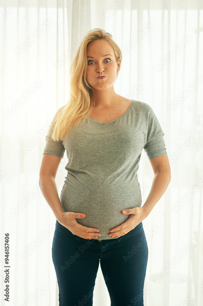 Pregnant, stomach or portrait of funny woman in home for pregnancy, prenatal healthcare or maternity leave. Crazy face, joke or silly mom with healthy newborn baby, wellness. or motherhood on break Pregnant, stomach or portrait of funny woman in home for pregnancy, prenatal healthcare or maternity leave. Crazy face, joke or silly mom with healthy newborn baby, wellness. or motherhood on break