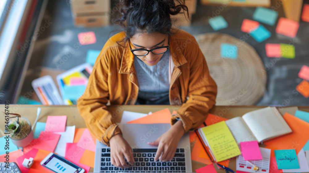 A university student participating in an online discussion via social media, with a laptop open to a study forum and notes scattered around A university student participating in an online discussion via social media, with a laptop open to a study forum and notes scattered around