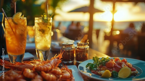 Delicious seafood dinner with refreshing iced cocktails at a beachside restaurant during sunset. photo