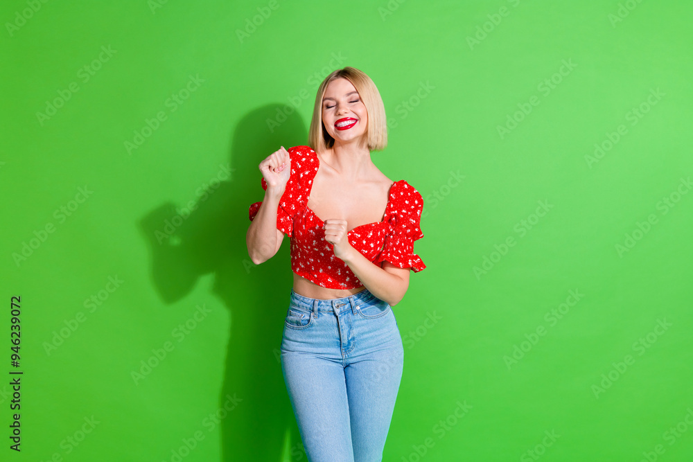 Photo of positive lovely cute girl woman wear red stylish clothes club dance isolated on green color background Photo of positive lovely cute girl woman wear red stylish clothes club dance isolated on green color background