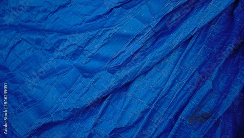 worn blue industrial plastic fabric as a background