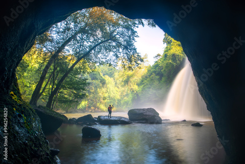 Fényképezés A man taking photo of the beauty of Haew Suwat Waterfall Khao Yai National Park Nakhon Ratchasima Province, Thailand