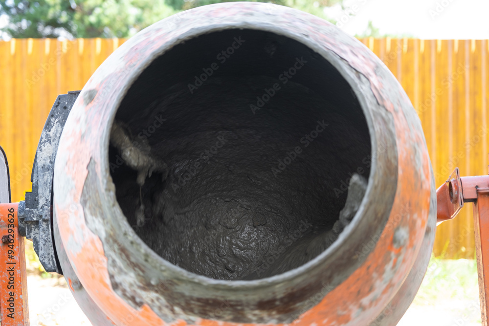 Mixing mortar in a handheld portable concrete mixer Mixing mortar in a handheld portable concrete mixer