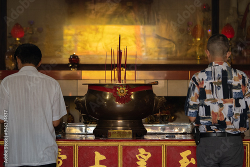 People worshipping at a monastery photo